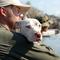 A striking image from Hurricane Katrina. Best Friends’ Jeff Popowich comforts a dog after it is rescued and brought into a boat in the streets of New Orleans.